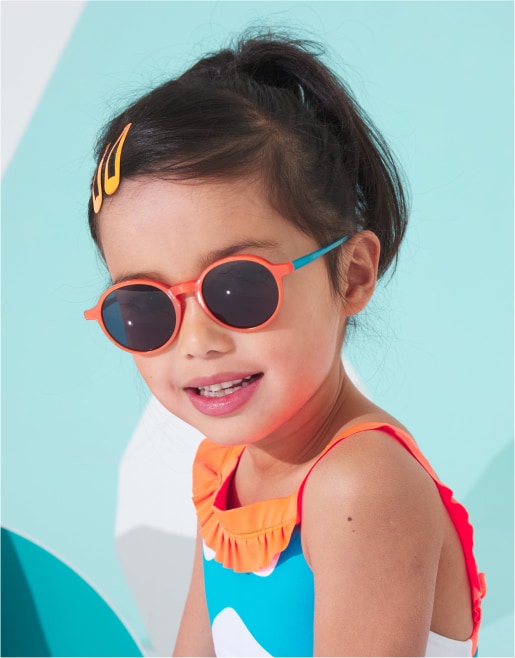 Petite fille en maillot de bain avec des lunettes de soleil